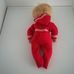 Szőke retro baba piros rugdalózóban