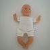 Tesco puha törzsű csecsemő baba sárga rugdalózóban