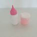 Fehér rózsaszín műanyag cumisüveg és itatópohár babákhoz